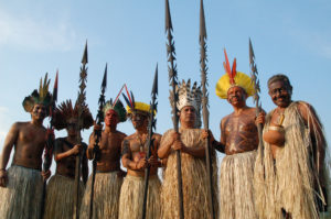 Traditionally garbed and armed with ritual spears, seven Yawanawá men pose for a rare photograph.