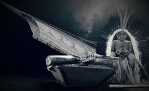 Elder Tatá Yawanawa sits in a greyscale photo