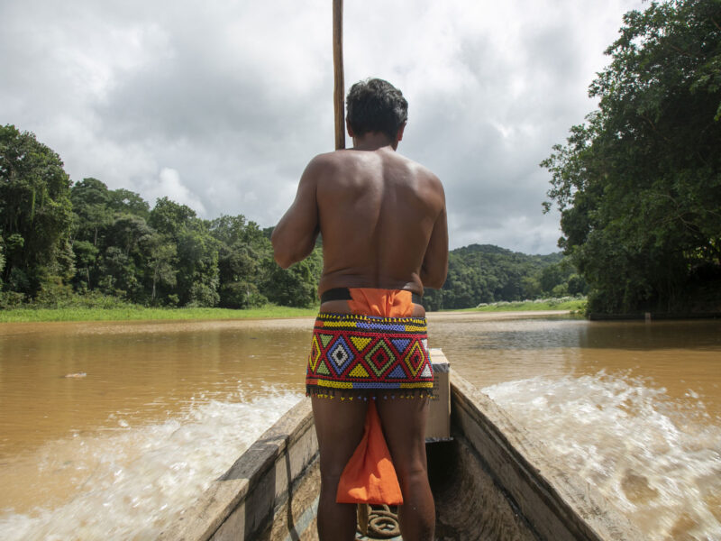 Yawanawa villager on bow of canoe
